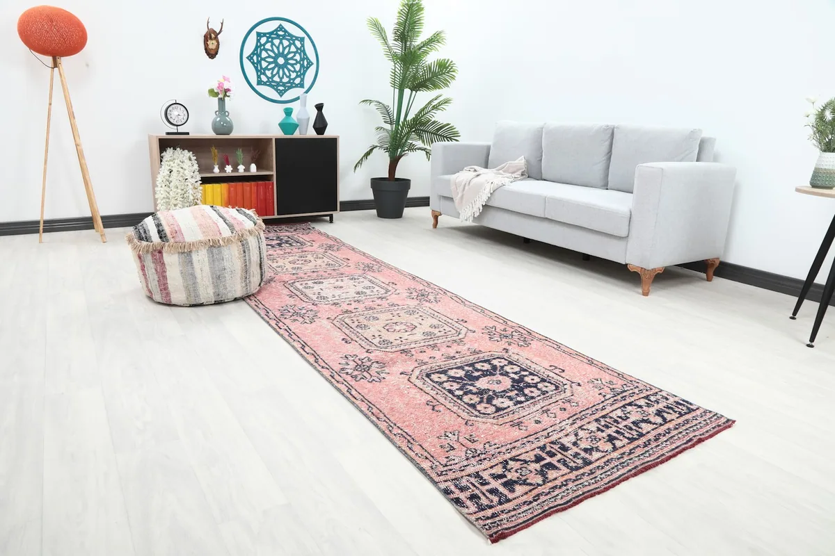 Angle view of the rose and navy runner rug enhancing a hallway or living space