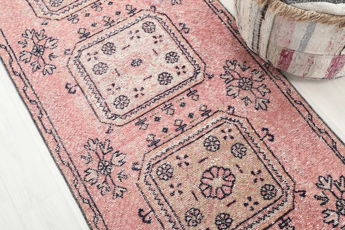 Close-up of the central geometric motifs and overall pattern of the rose vintage runner