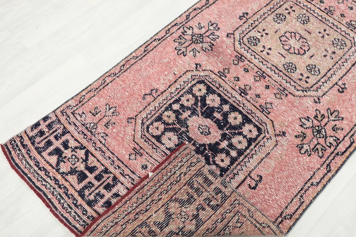 View of the runner folded to show the back and front, highlighting the hand-knotted construction