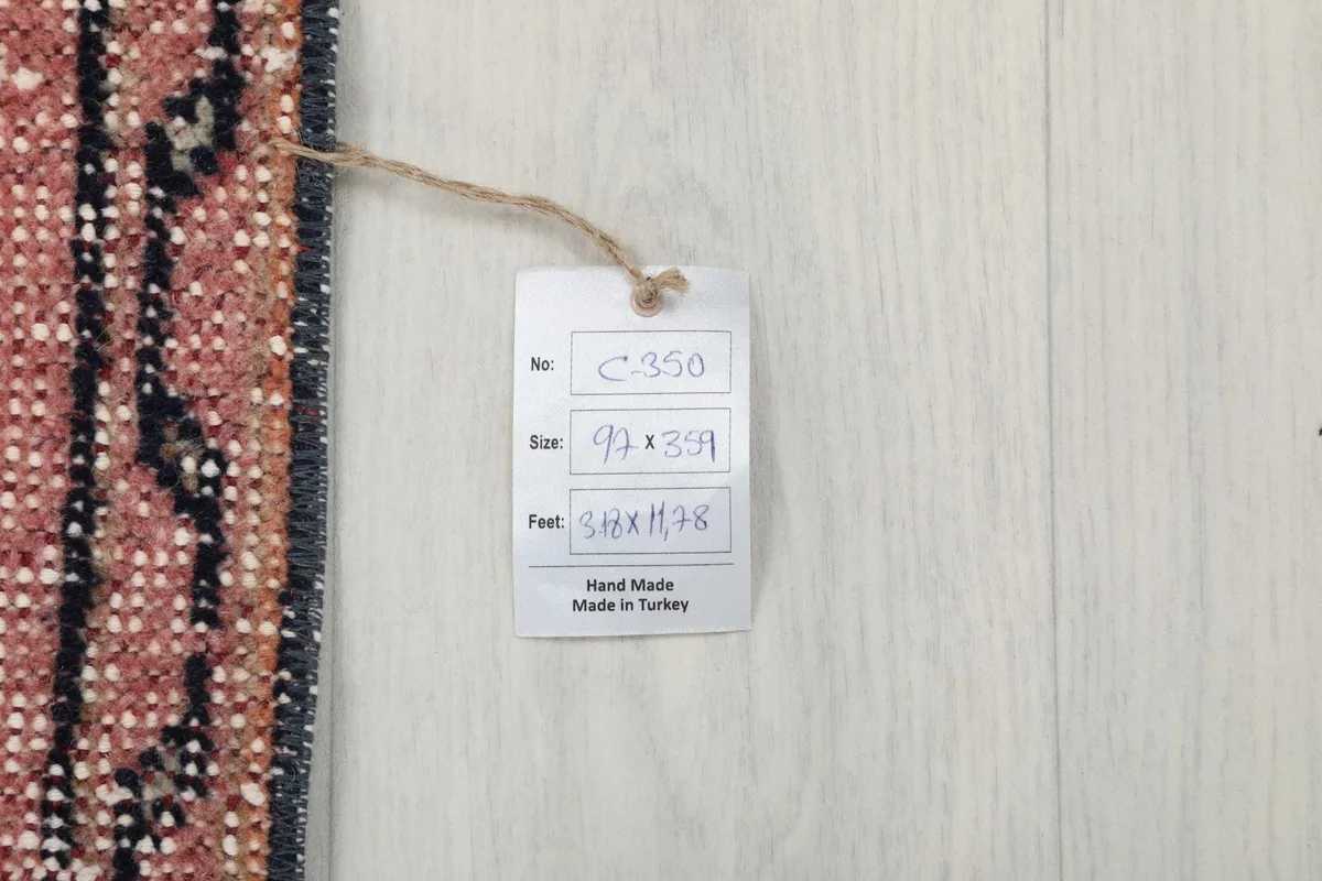 Tag displaying the rug's size in feet and centimeters, confirming it is hand-made in Turkey