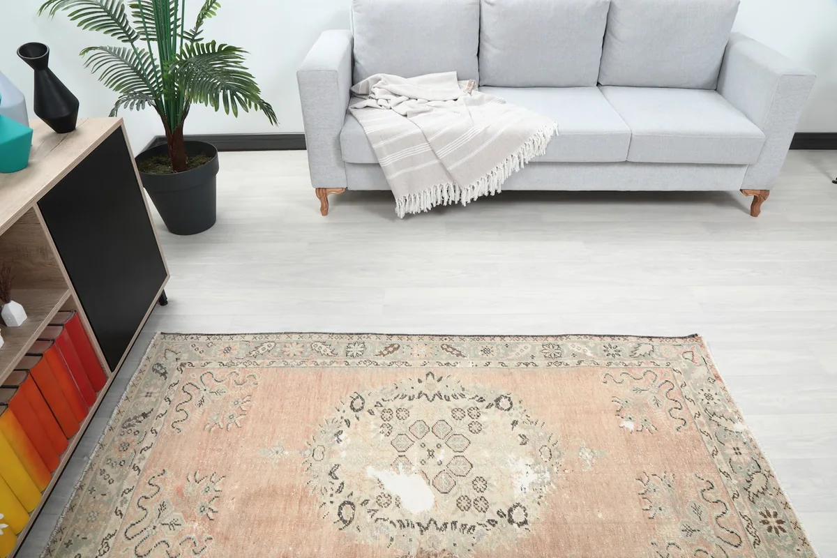 Overhead angle view of the rug in the living room, highlighting the central medallion and surrounding decor.