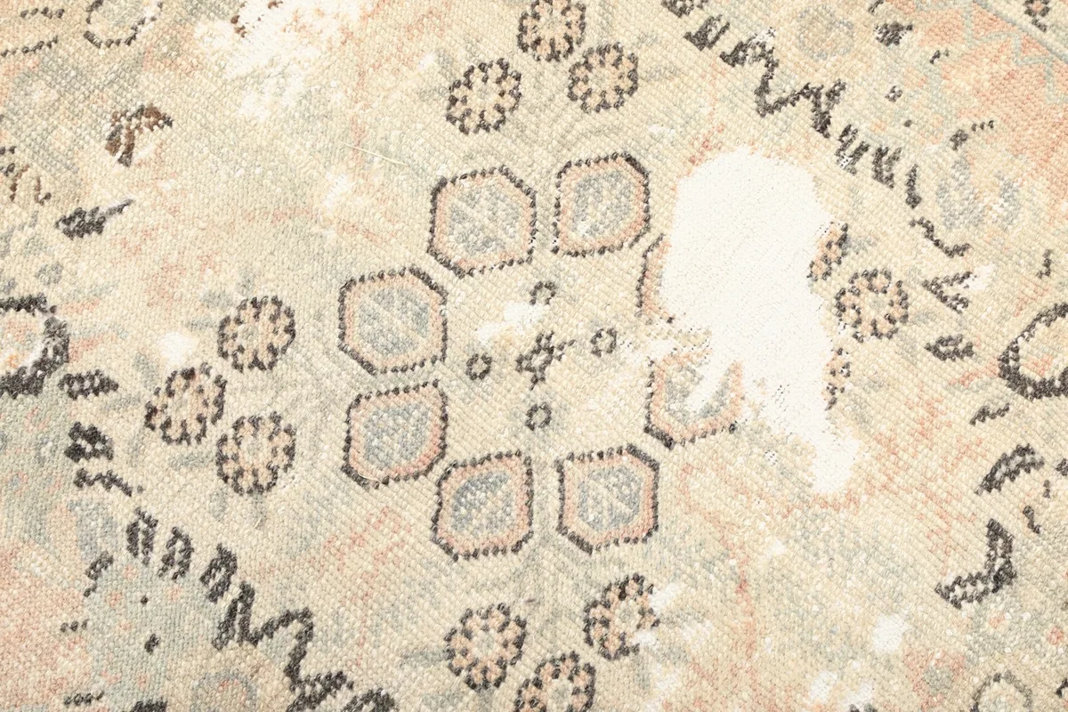 Detailed view of the medallion's center, highlighting the intricate motifs and variations in the wool pile.