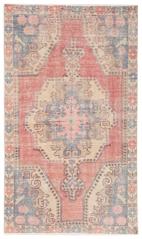 Full overhead view of the vintage Anatolian rug with a rose field and medallion pattern on a white background