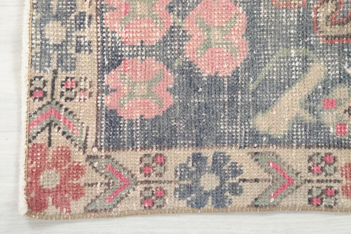 Detailed view of the corner border pattern with floral motifs and geometric elements