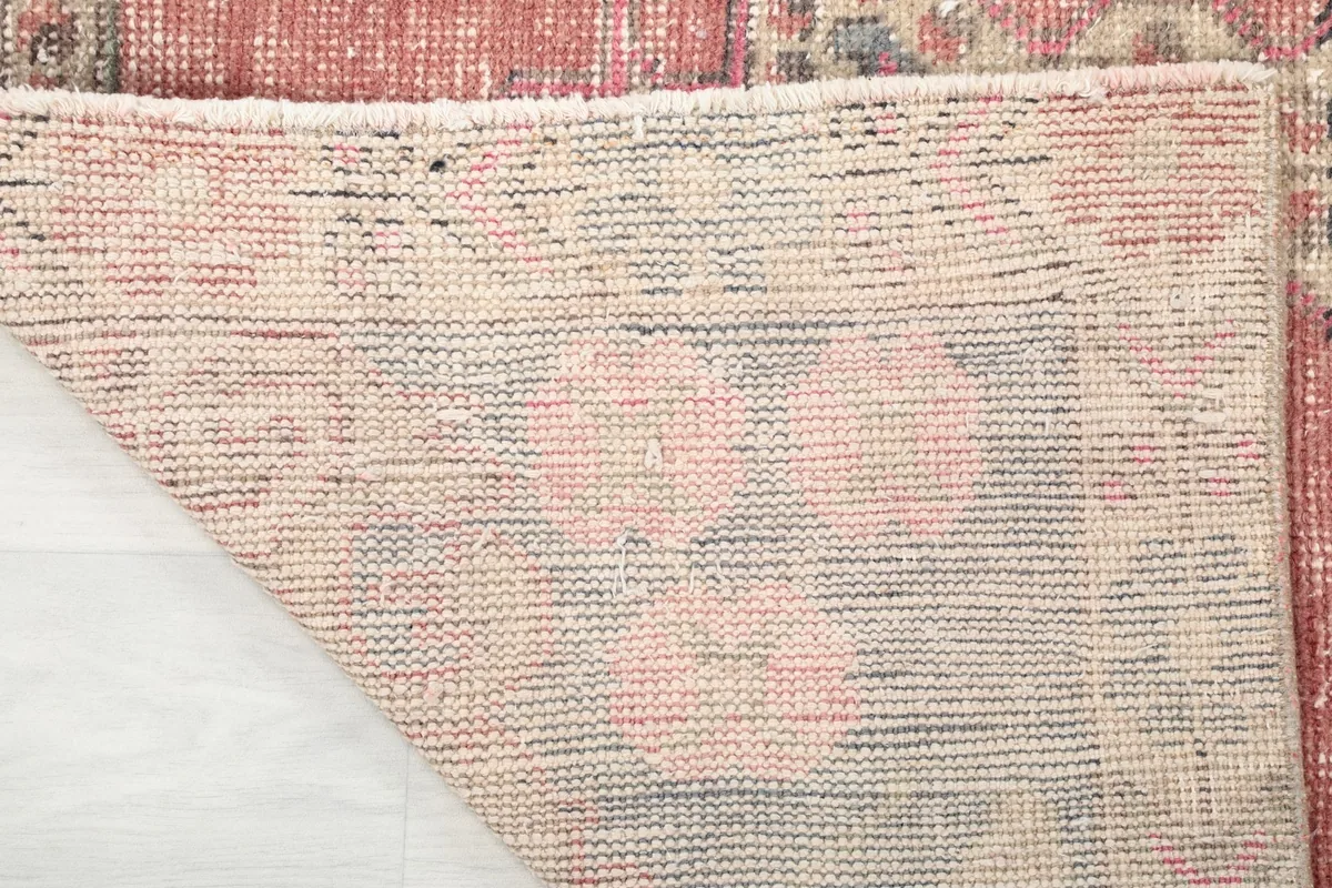 Underside of the hand-knotted rug, showing the cotton foundation and knotting structure