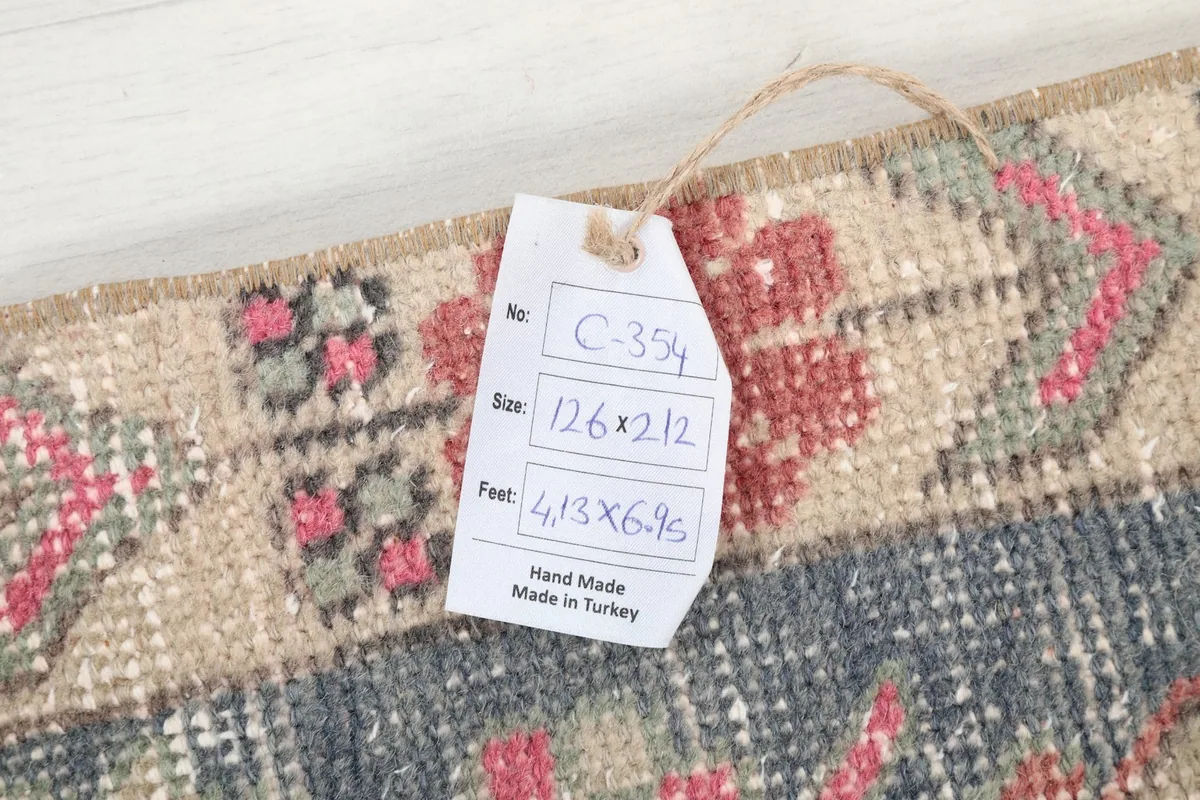 Close-up of the rug's tag, indicating size and origin, attached to the border