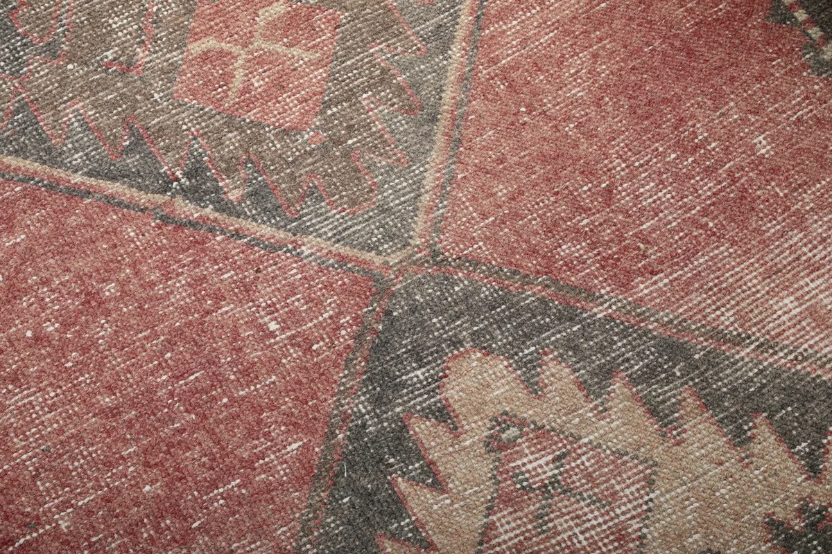Close-up of the low wool pile and the hand-knotted texture with natural wear