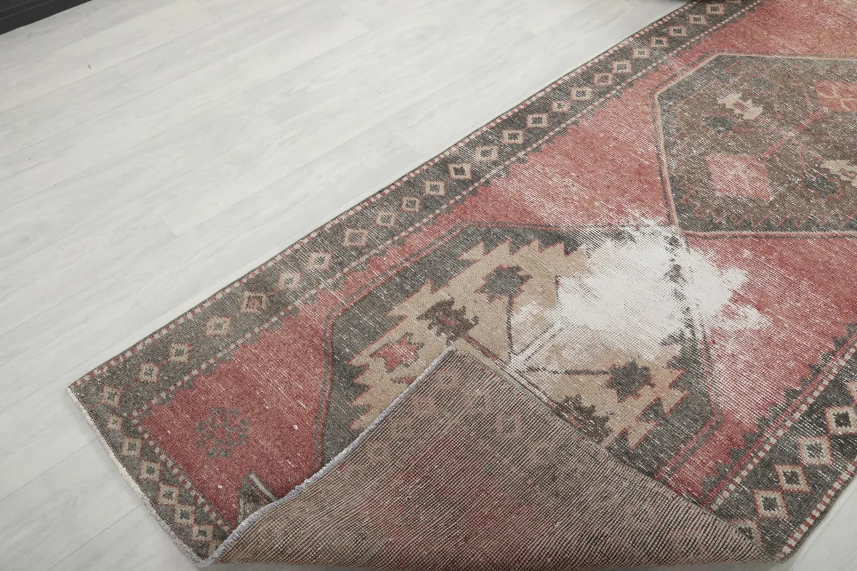 View of the rug folded to show the thickness and flexibility of the material