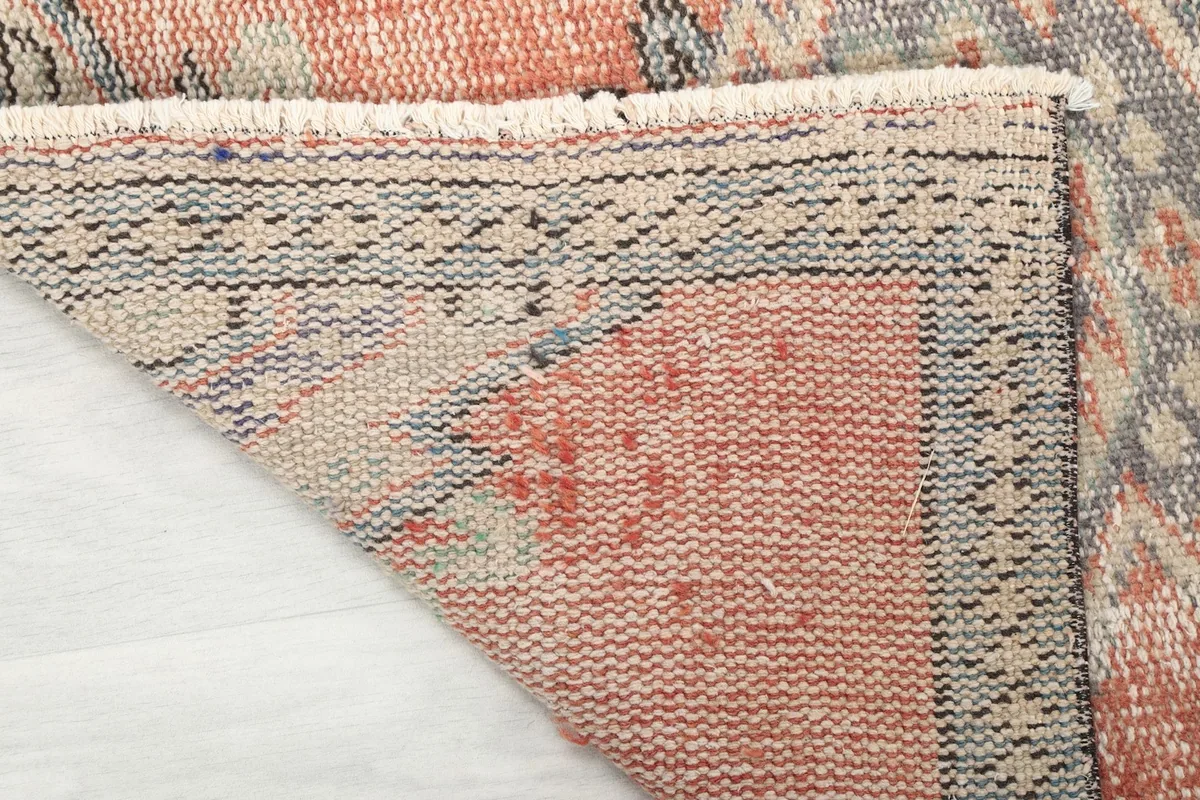 Underside view of the rug, showing the cotton foundation and hand-knotted construction