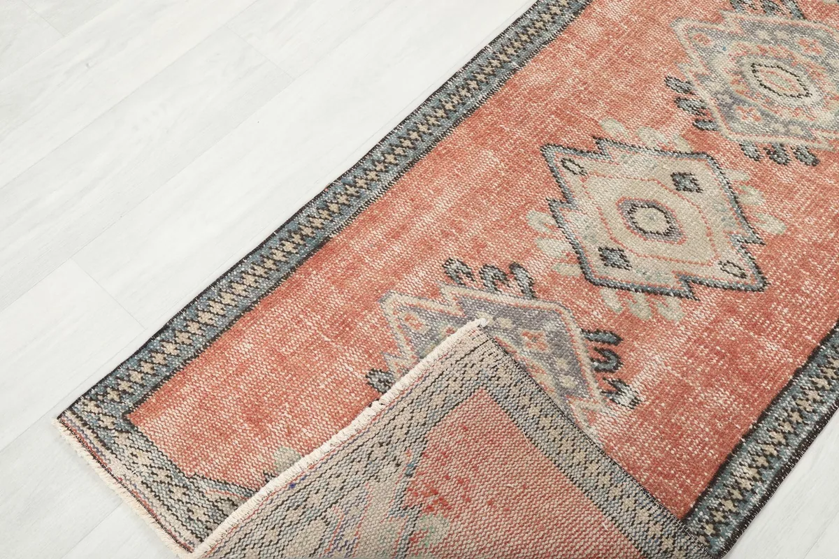 View showing a folded corner of the runner rug, revealing its thickness and weave