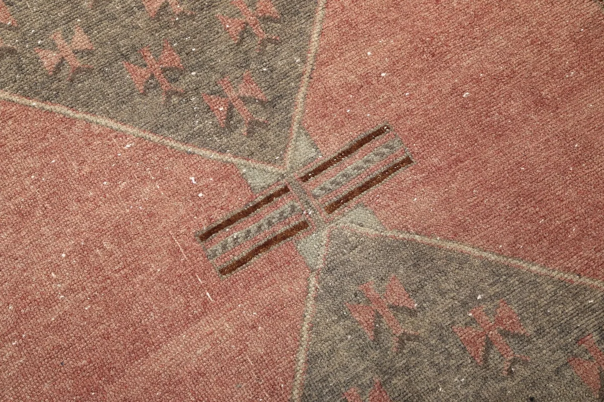 Detailed close-up of the central medallion connection, showing the subtle geometric patterns.