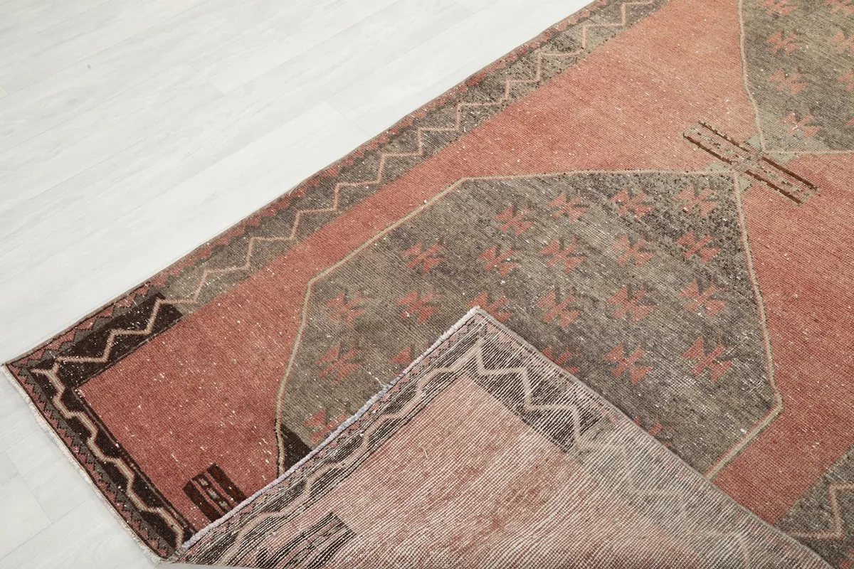 View of the rug folded to show the front and back, illustrating the hand-knotted construction.