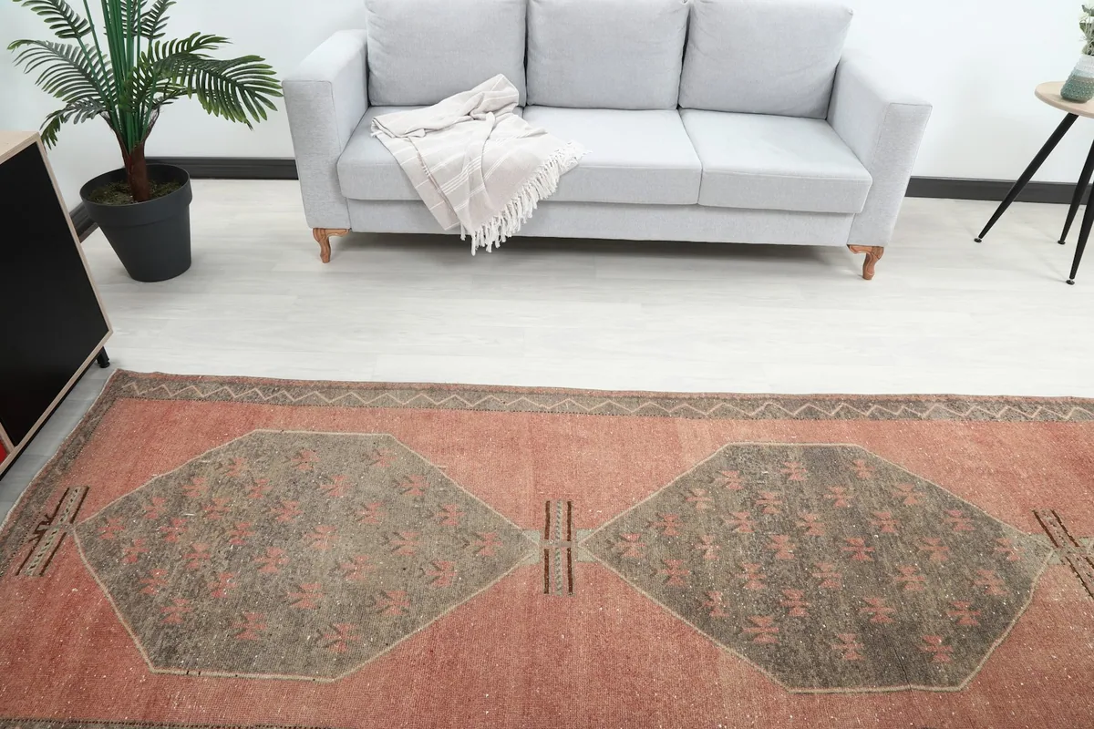 Overhead view of the runner in a room, emphasizing the geometric medallions and field color.