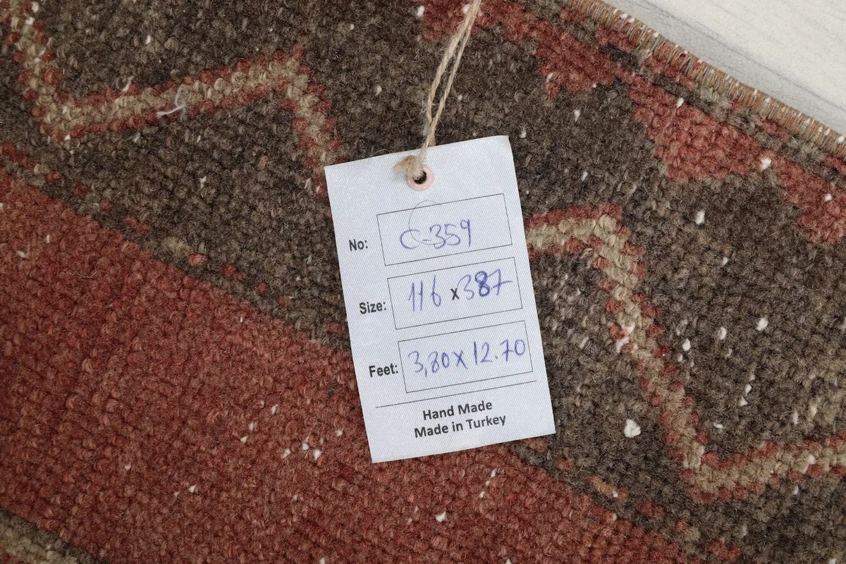 Identification tag showing the rug's hand-made origin and dimensions.