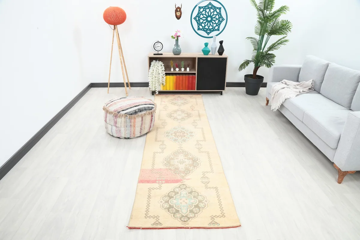 Ivory geometric runner rug displayed in a modern room setting with light flooring and furniture.