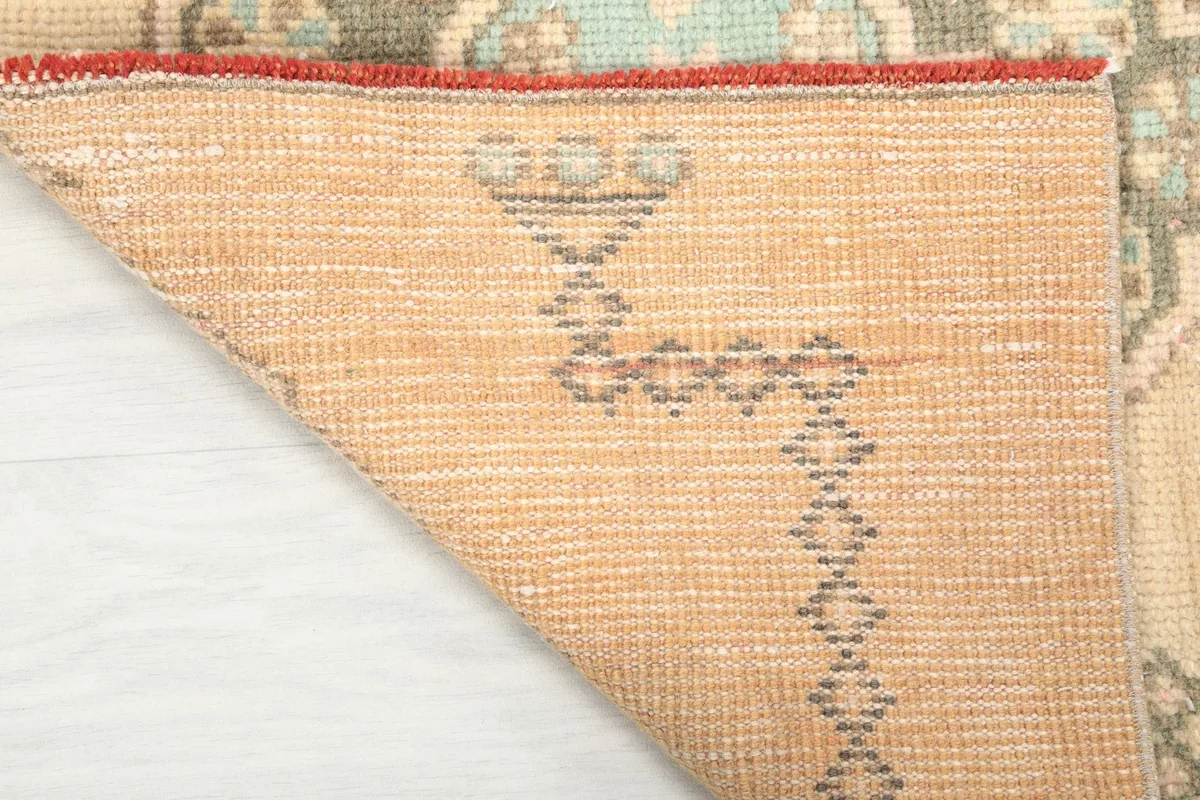 Close-up of the back of the hand-knotted wool runner, revealing the cotton foundation and knotting.