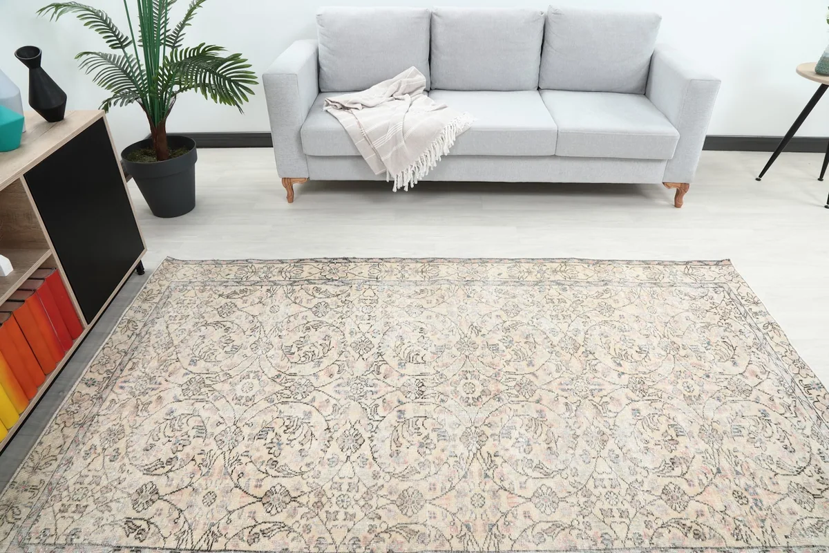 Overhead view of the ivory vintage rug in a living room, showcasing its full design and size.