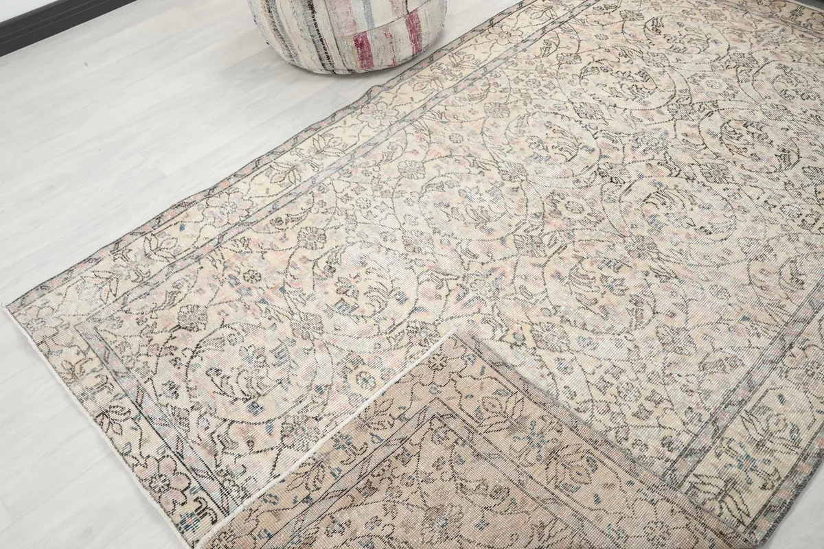 View of the rug folded to show the wool pile and cotton foundation, with patterns visible.