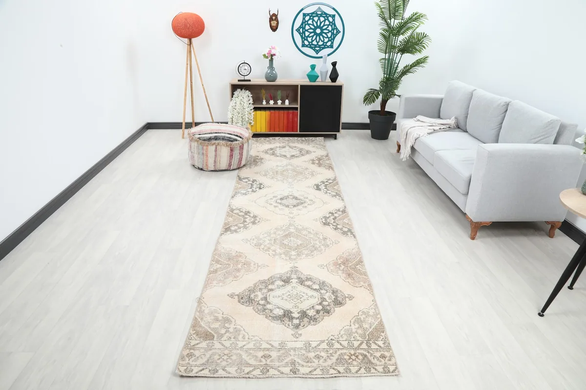 Vintage Anatolian runner rug in a modern living room setting, showcasing its length and pattern
