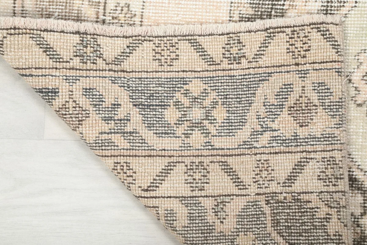 Underside of the hand-knotted rug, revealing the cotton foundation and knotting structure