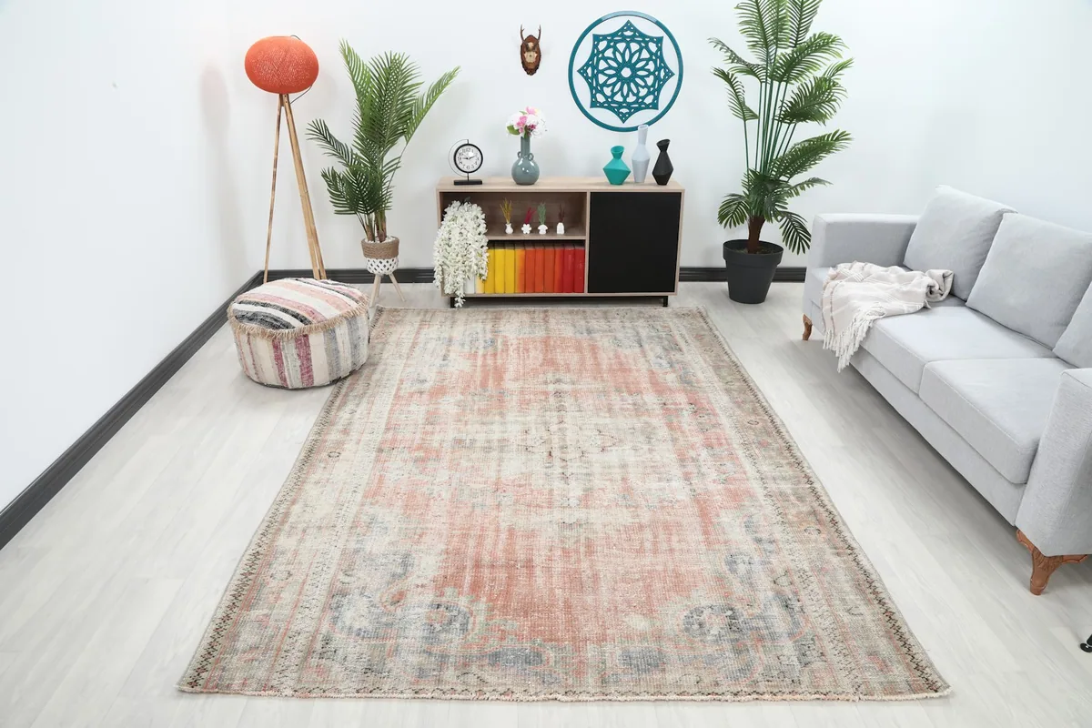 Vintage Anatolian rose and beige rug displayed in a living room setting with modern furniture