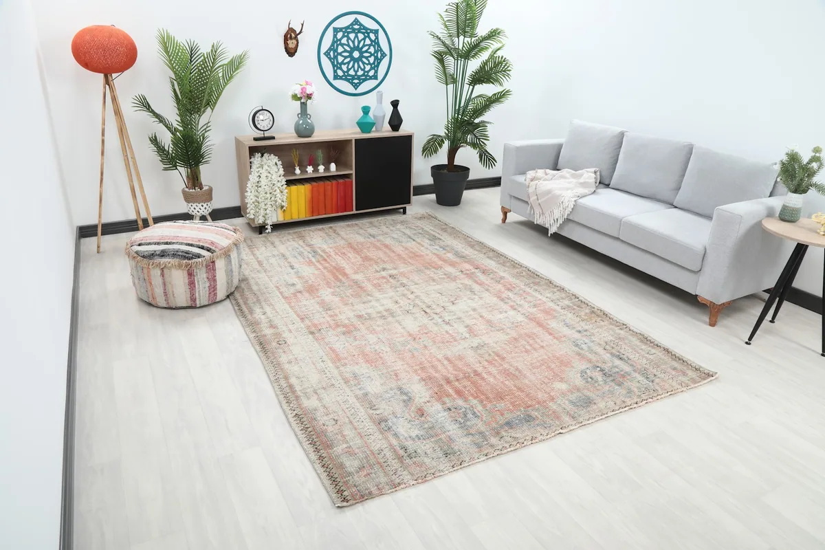 Angle view of the hand-knotted vintage rug showcasing its size and colors within a room