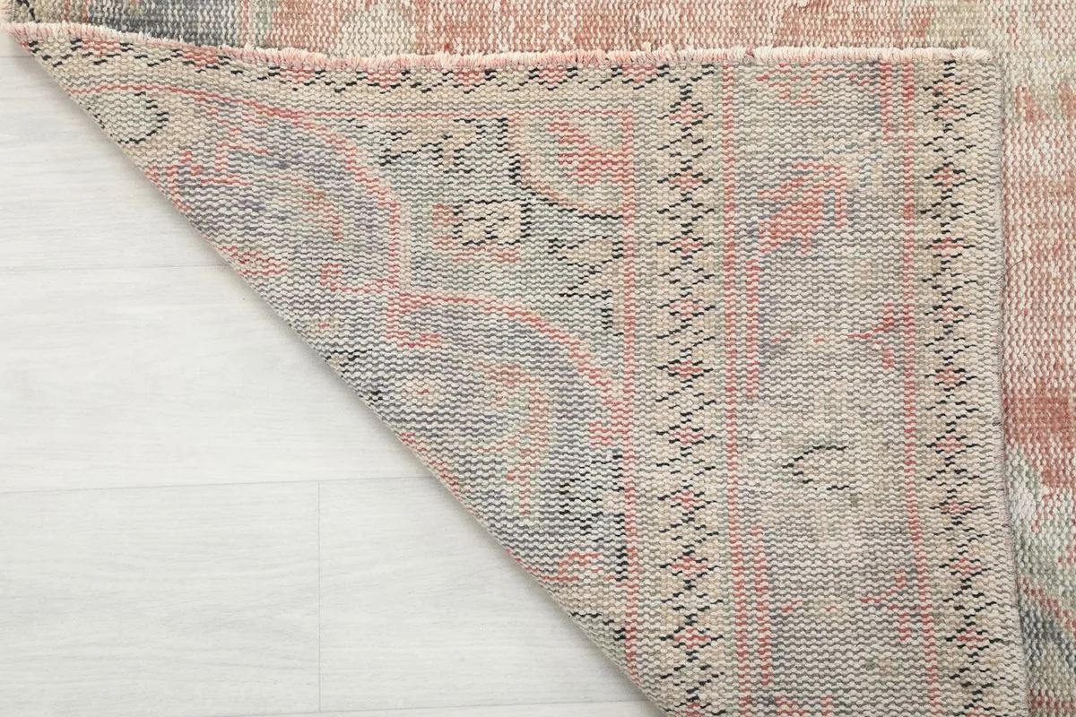 Underside view of the hand-knotted vintage rug, showing the cotton foundation and knot structure