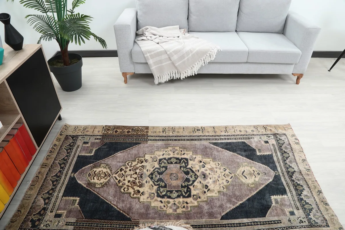 Overhead view of the vintage rug from a slight distance, highlighting its proportions in the room.