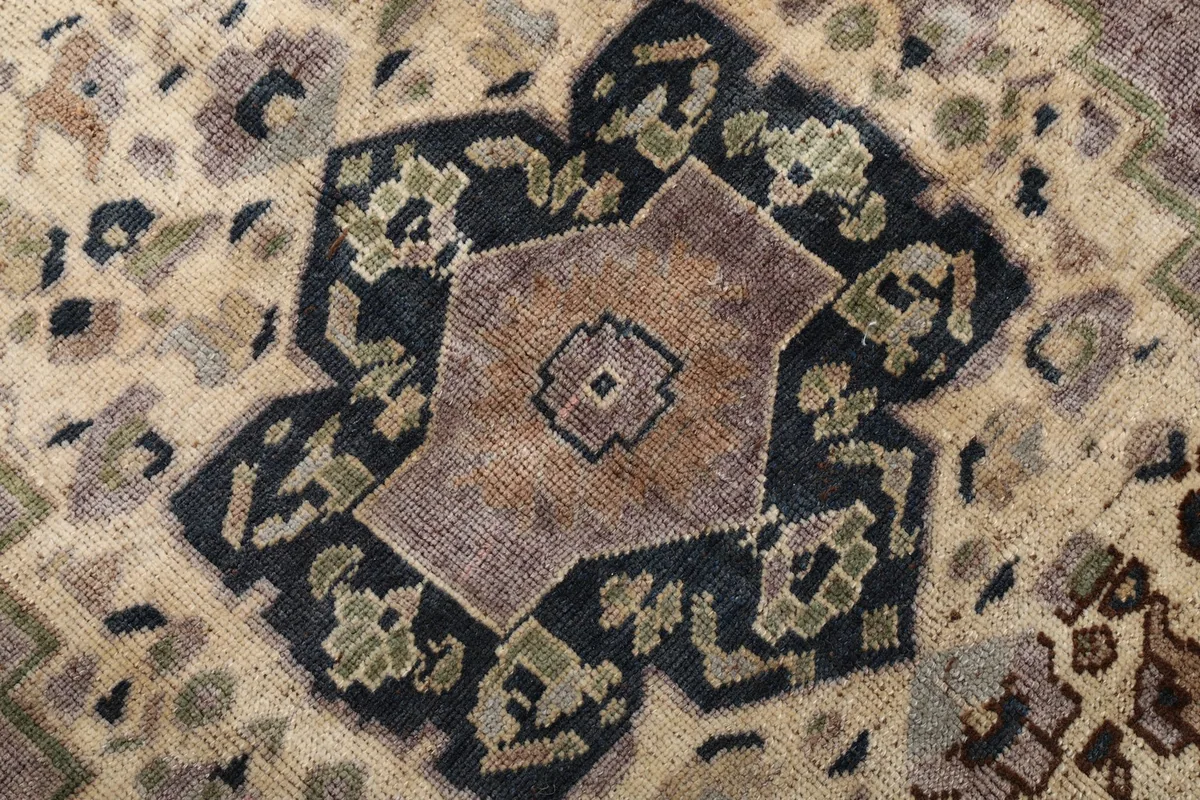 Close-up of the innermost part of the medallion, revealing the subtle color shifts and wool pile.