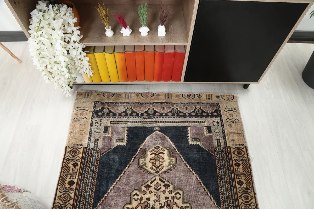 Direct overhead shot focusing on the upper half of the rug, detailing the geometric border and field design.