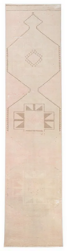 Full overhead view of the 2'11" x 12'7" rose beige runner rug with geometric tan motifs on a white background.