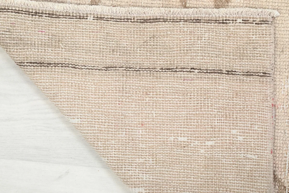 Underside view of the hand-knotted wool pile on a cotton foundation, showing the rug's construction.
