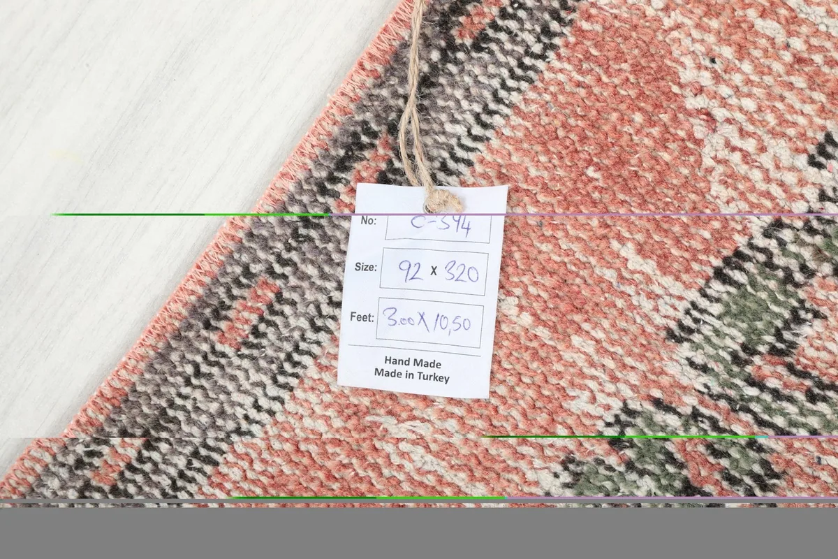 Tag on the back of the rug displaying size and origin details, confirming hand-made in Turkey.
