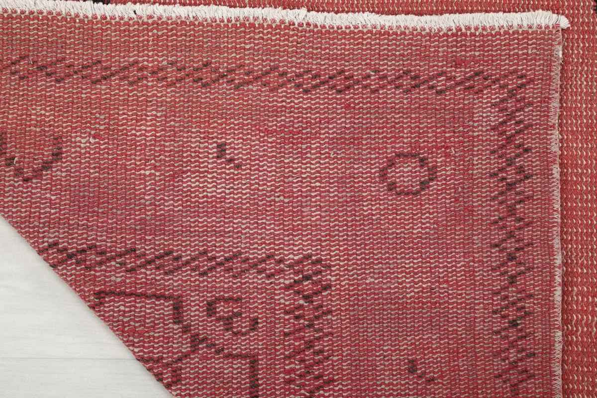 Close-up of the back of the rug, revealing the tightly woven cotton foundation and knots