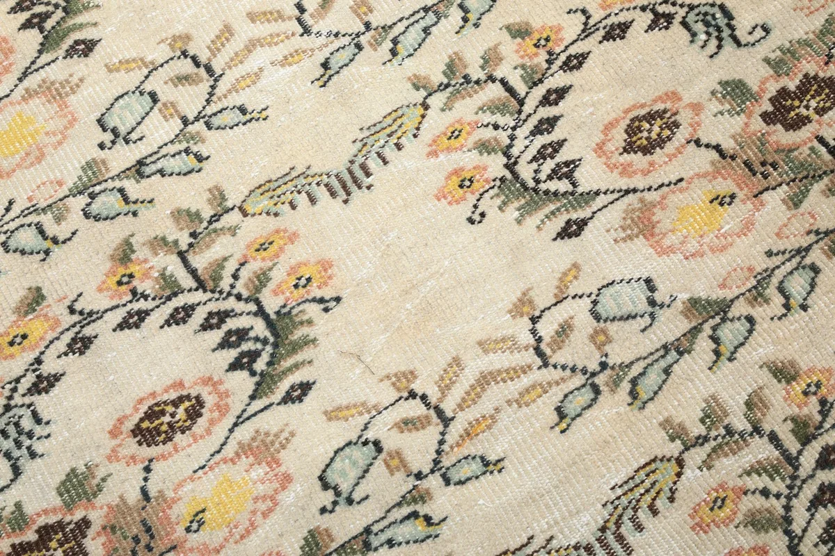 Close-up of the low wool pile, revealing the hand-knotted texture and slight patina