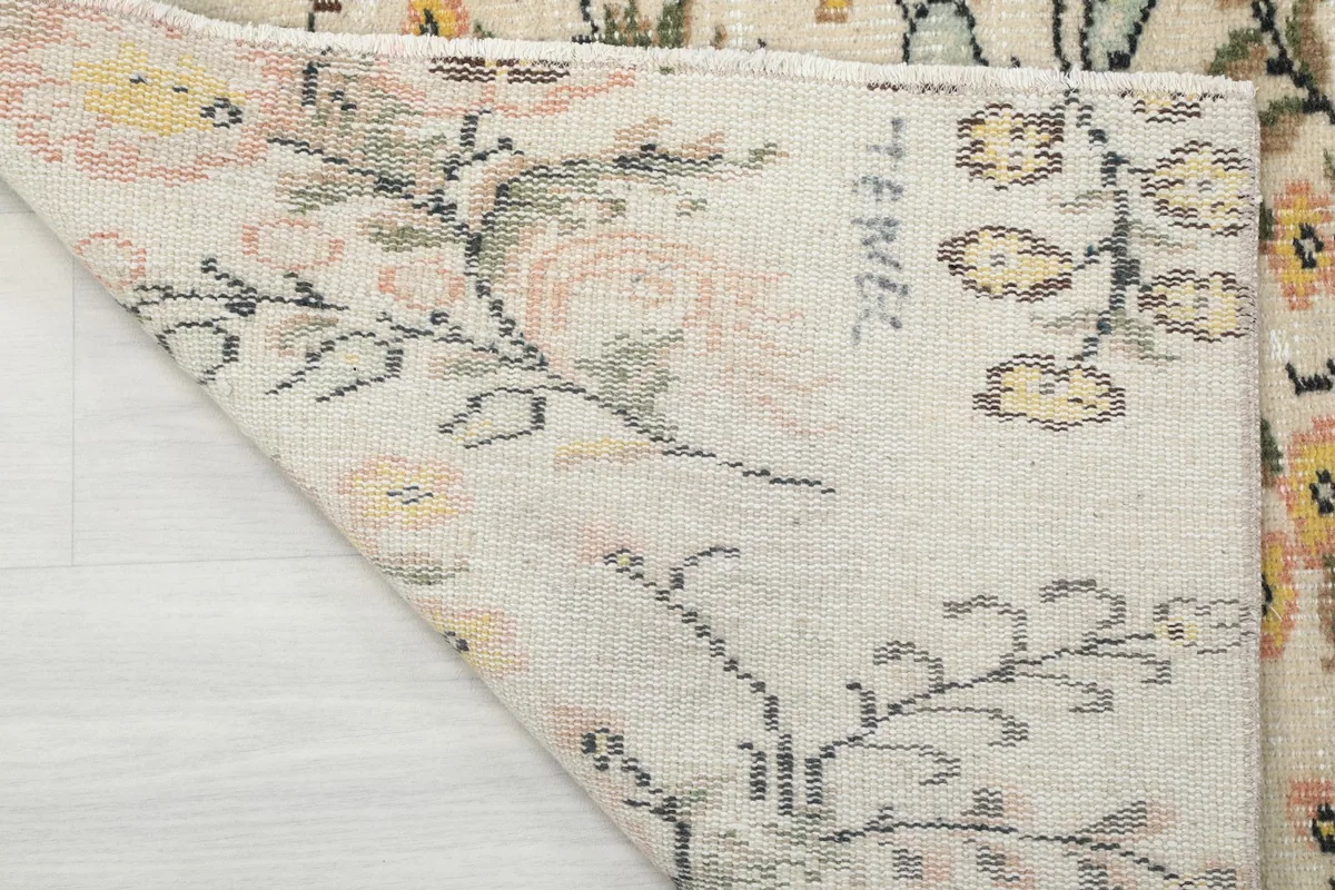 Underside of the rug, displaying the hand-knotted construction and the tightly woven cotton foundation