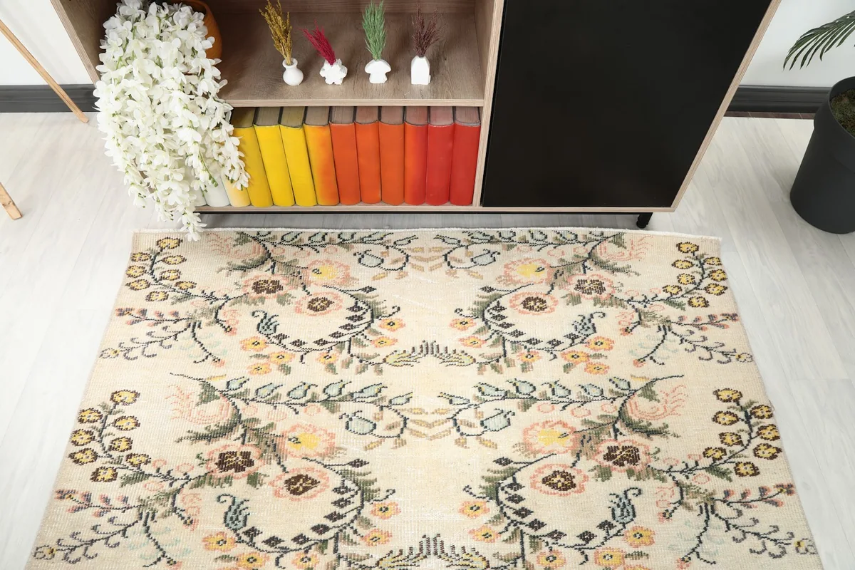 Direct overhead shot of the rug's center, showing the repeating botanical design