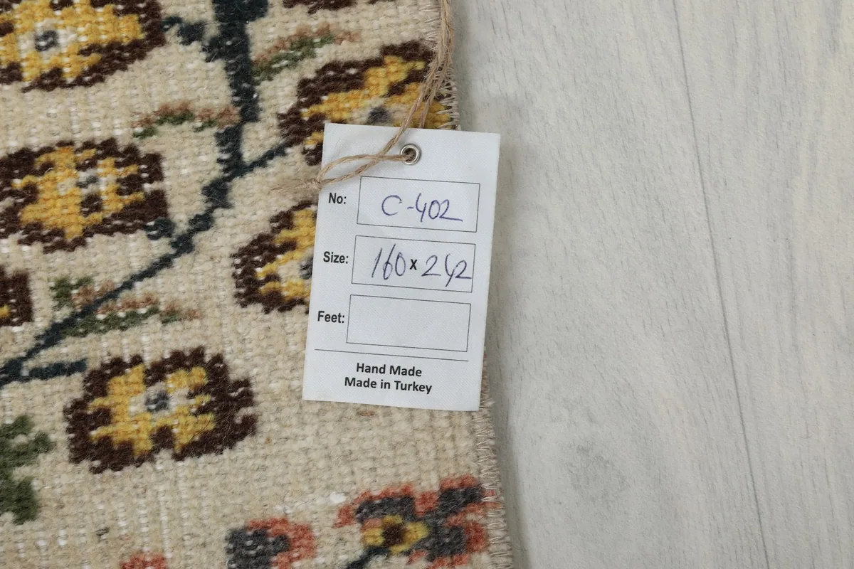 Tag on the back of the rug indicating its size and origin as hand-made in Turkey