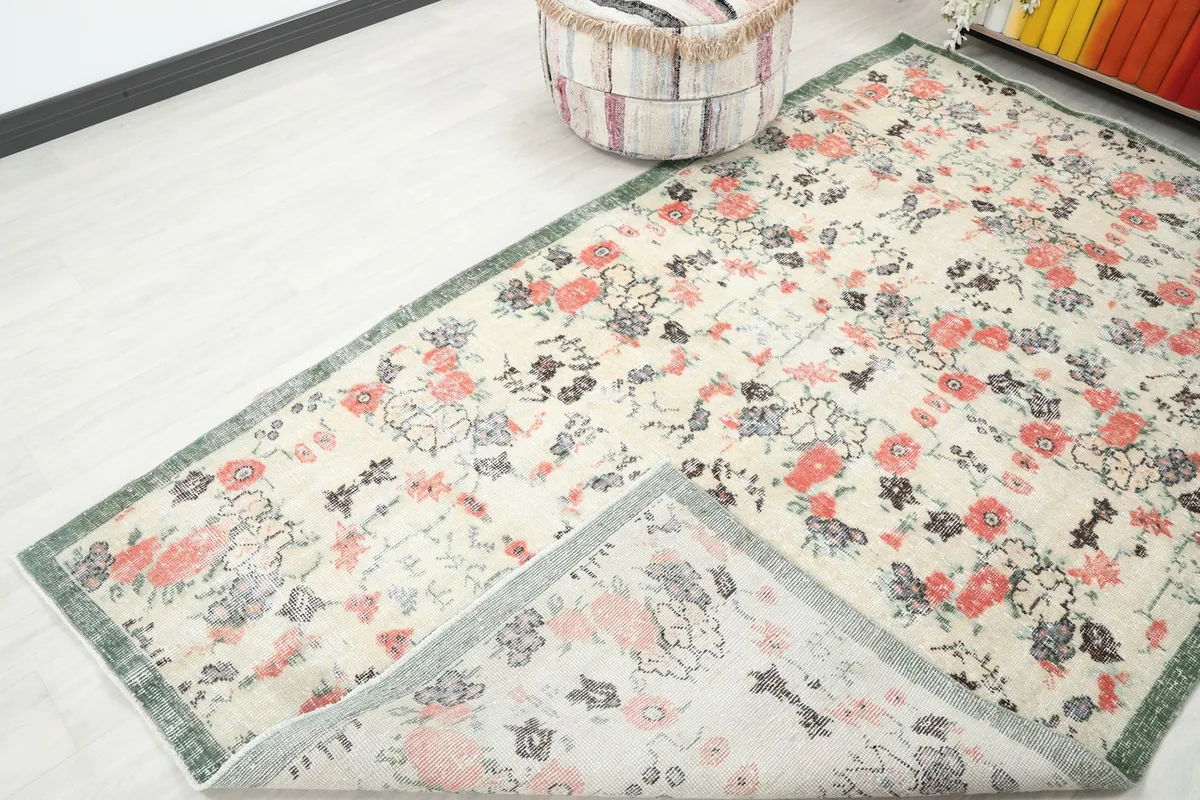 Partial view of the rug's underside, revealing the cotton foundation and hand-knotted structure.
