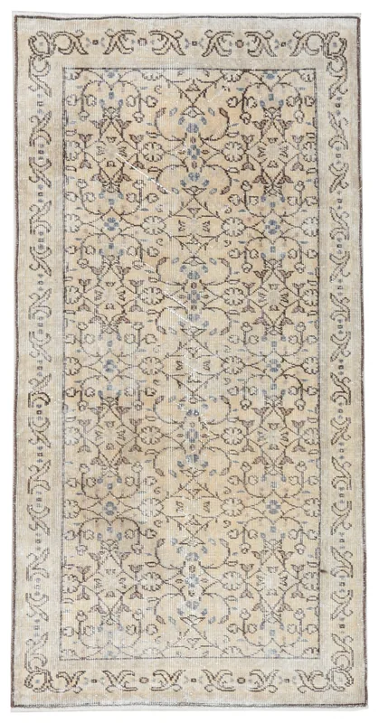 Full overhead view of the beige and brown floral vintage Anatolian rug