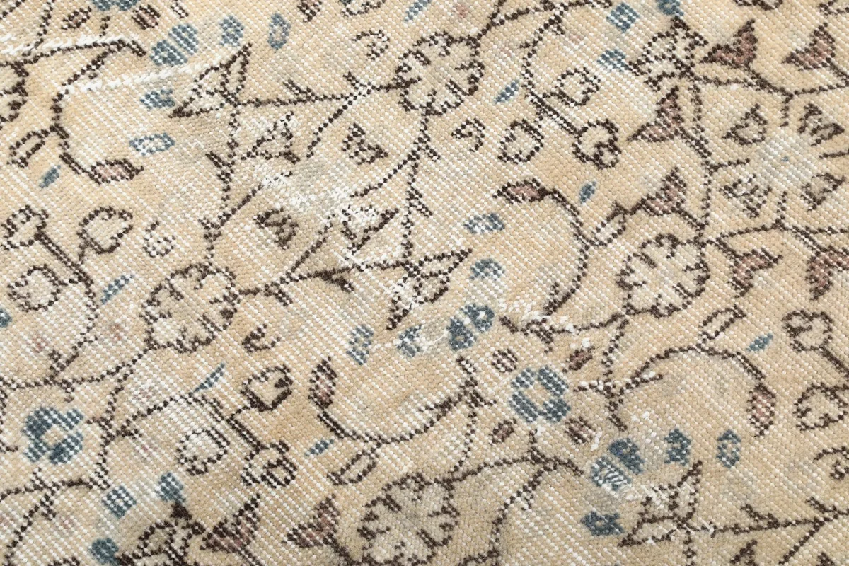 Close-up of the low wool pile, showing individual knots and subtle blue accents