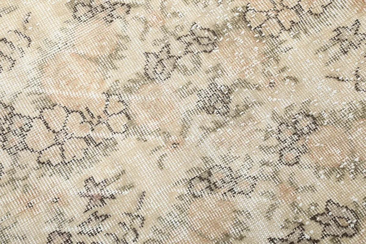 Close-up of the distressed wool pile, highlighting the vintage texture and colors
