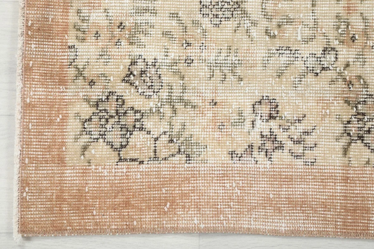Corner detail showing the transition from the cream field to the orange border