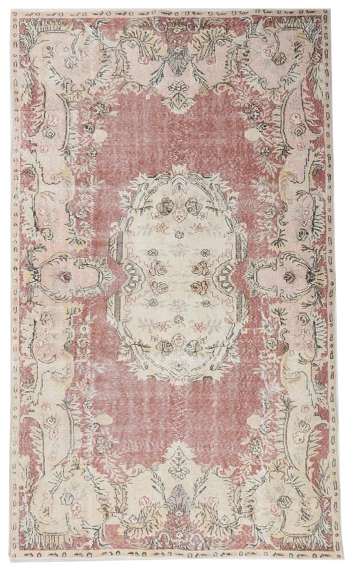 Top-down view of the 5'7" x 9'6" rose and ivory Anatolian vintage rug with central medallion.