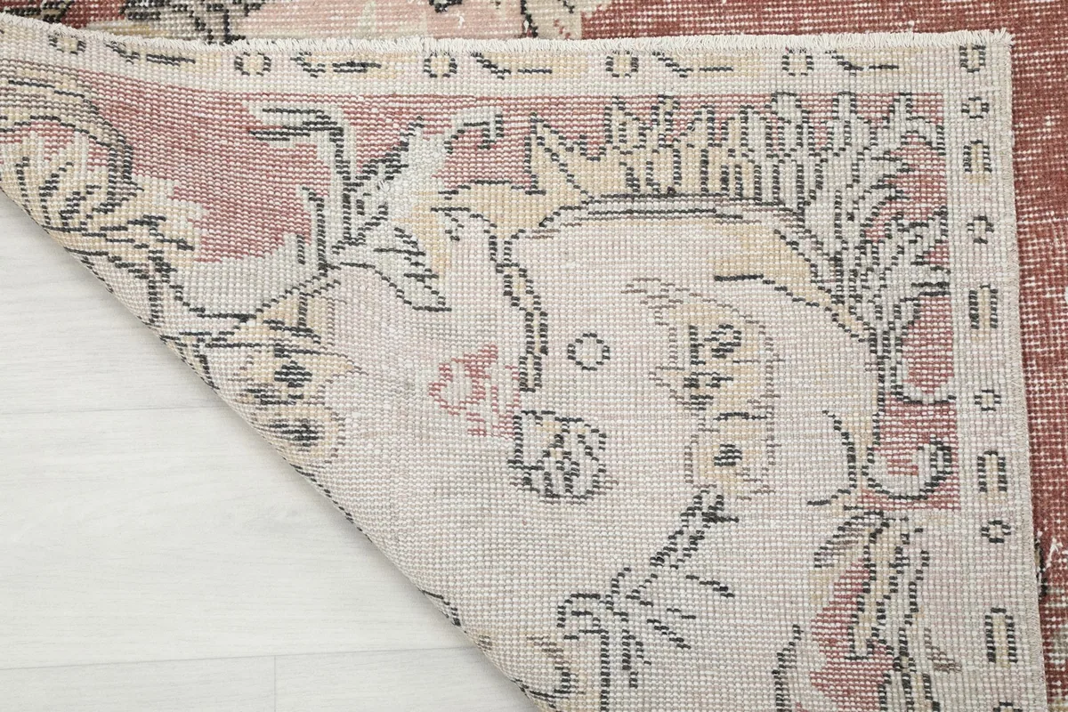 Underside view of the hand-knotted rug, showing the cotton foundation and construction details.