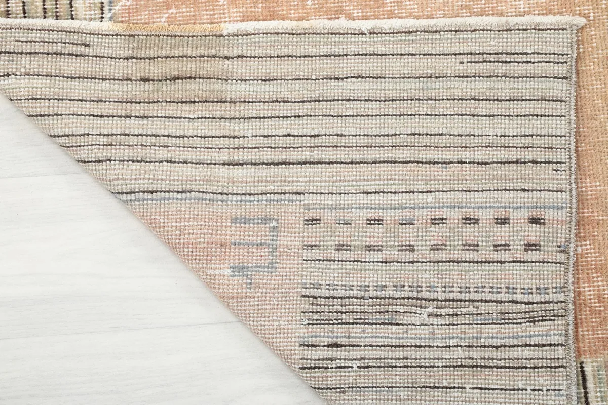Underside view of the hand-knotted cotton foundation and wool pile of the Anatolian rug.