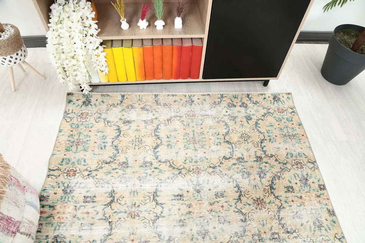 Diagonal view of the beige floral rug highlighting its intricate motifs and color variations