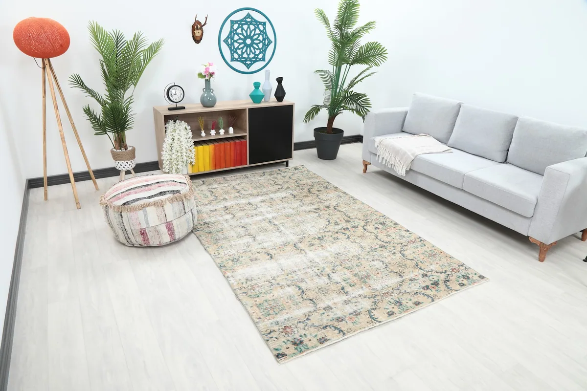 Angle view of the beige floral rug showcasing its size and colors in a living space