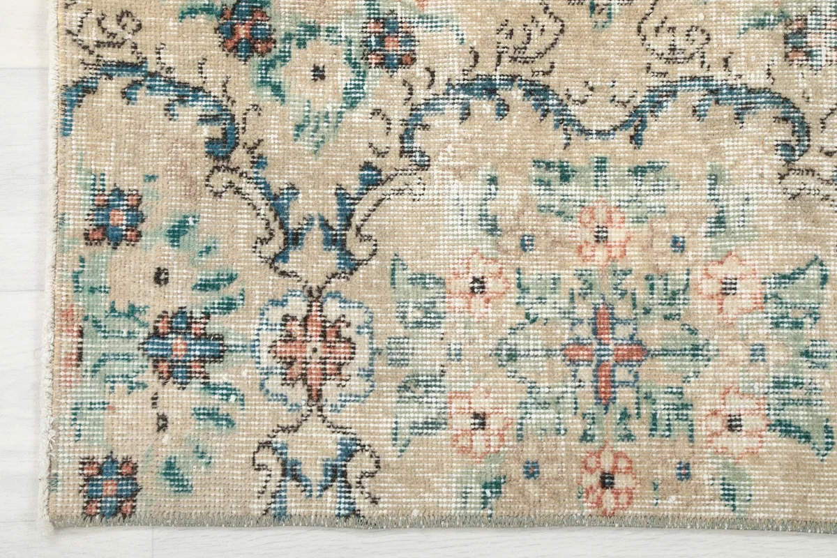Corner detail of the rug, showing the border and the subtle color shifts in the design