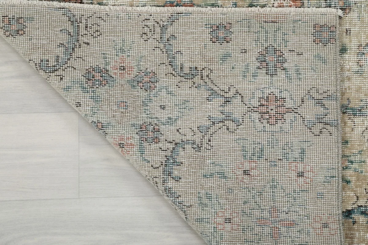 Close-up of the rug's back, revealing the hand-knotted structure and cotton foundation